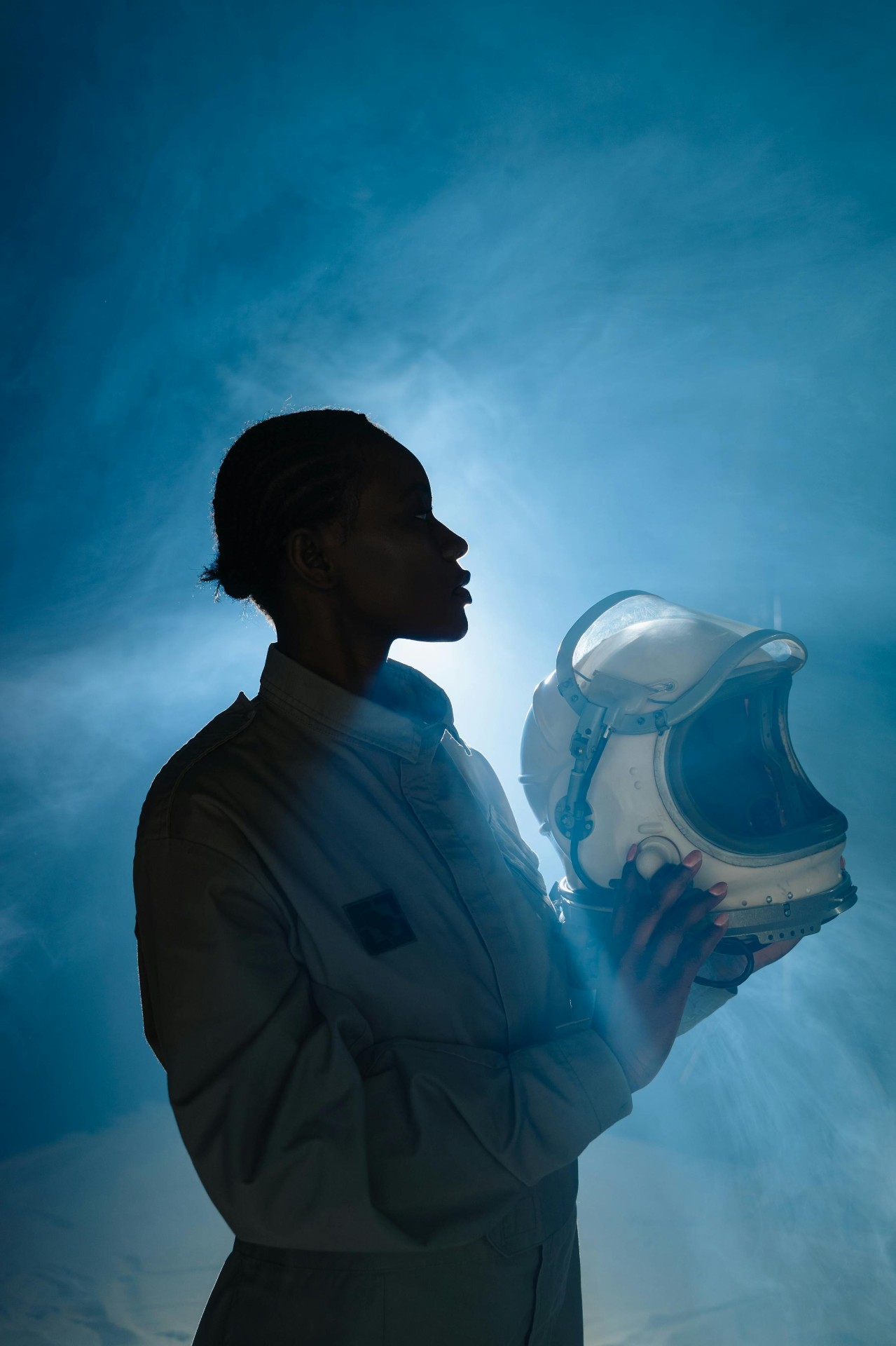Founder's message visual — silhouette holding an astronaut helmet